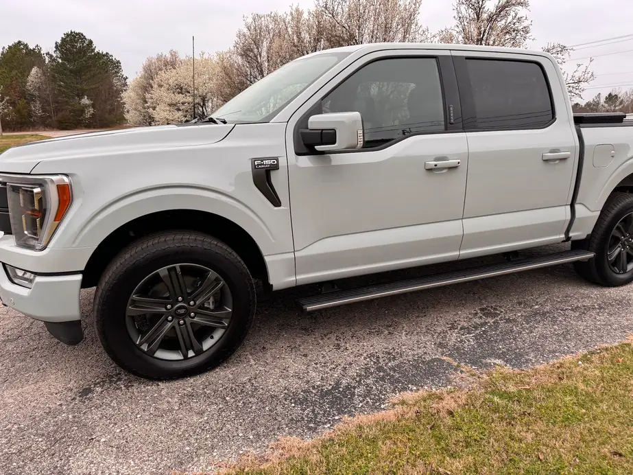 A finished white Ford F-150 after bodywork at Collision South